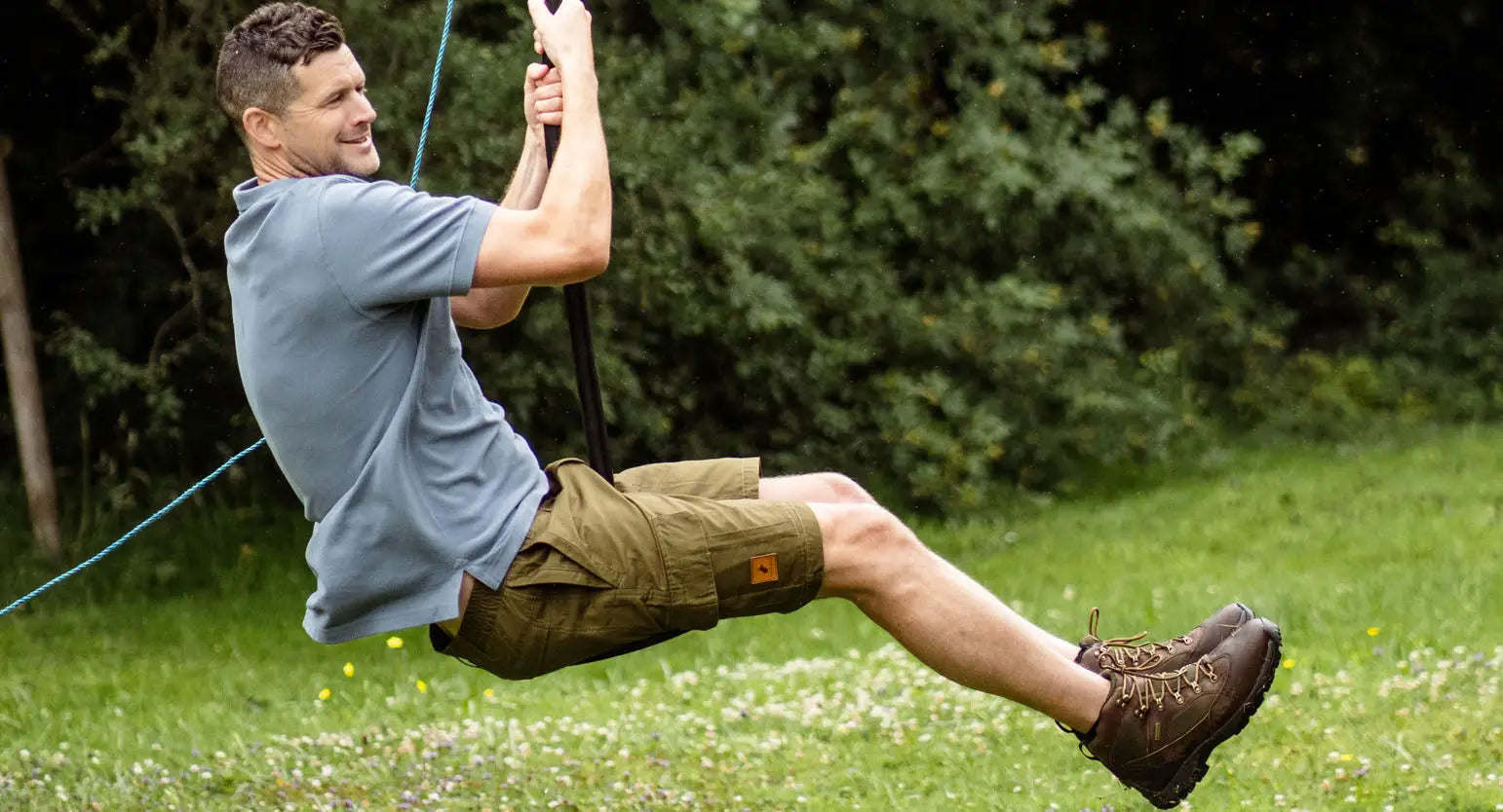 Man enjoying a swing in the forest trail, perfect for your outdoor adventure in style.