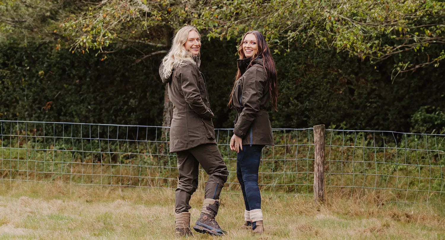 Two women rocking the AW24 Collection in stylish country sport clothing outdoors.