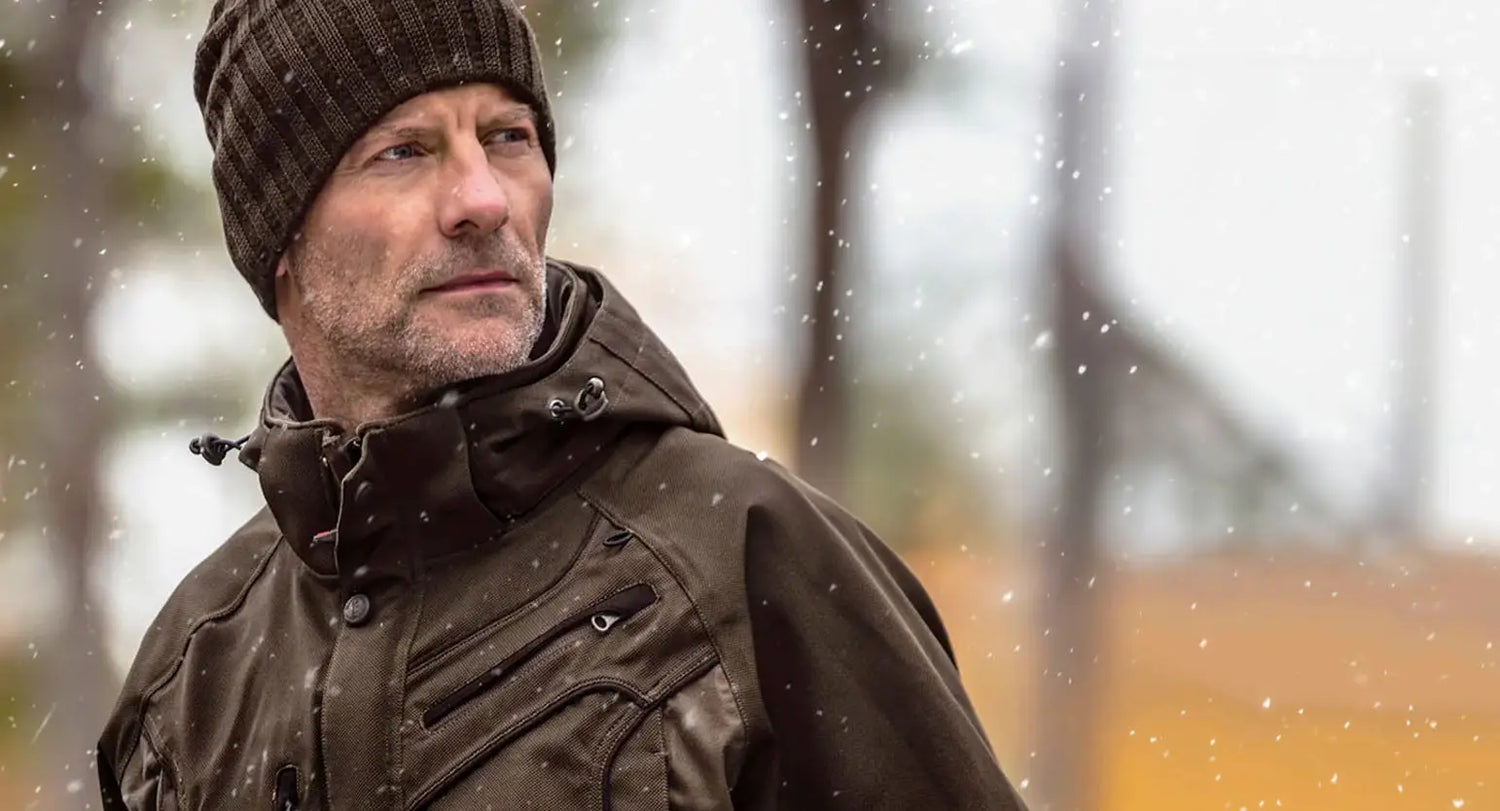 Middle-aged man in brown winter coat and knit hat showcasing Ridgeline Monsoon style.