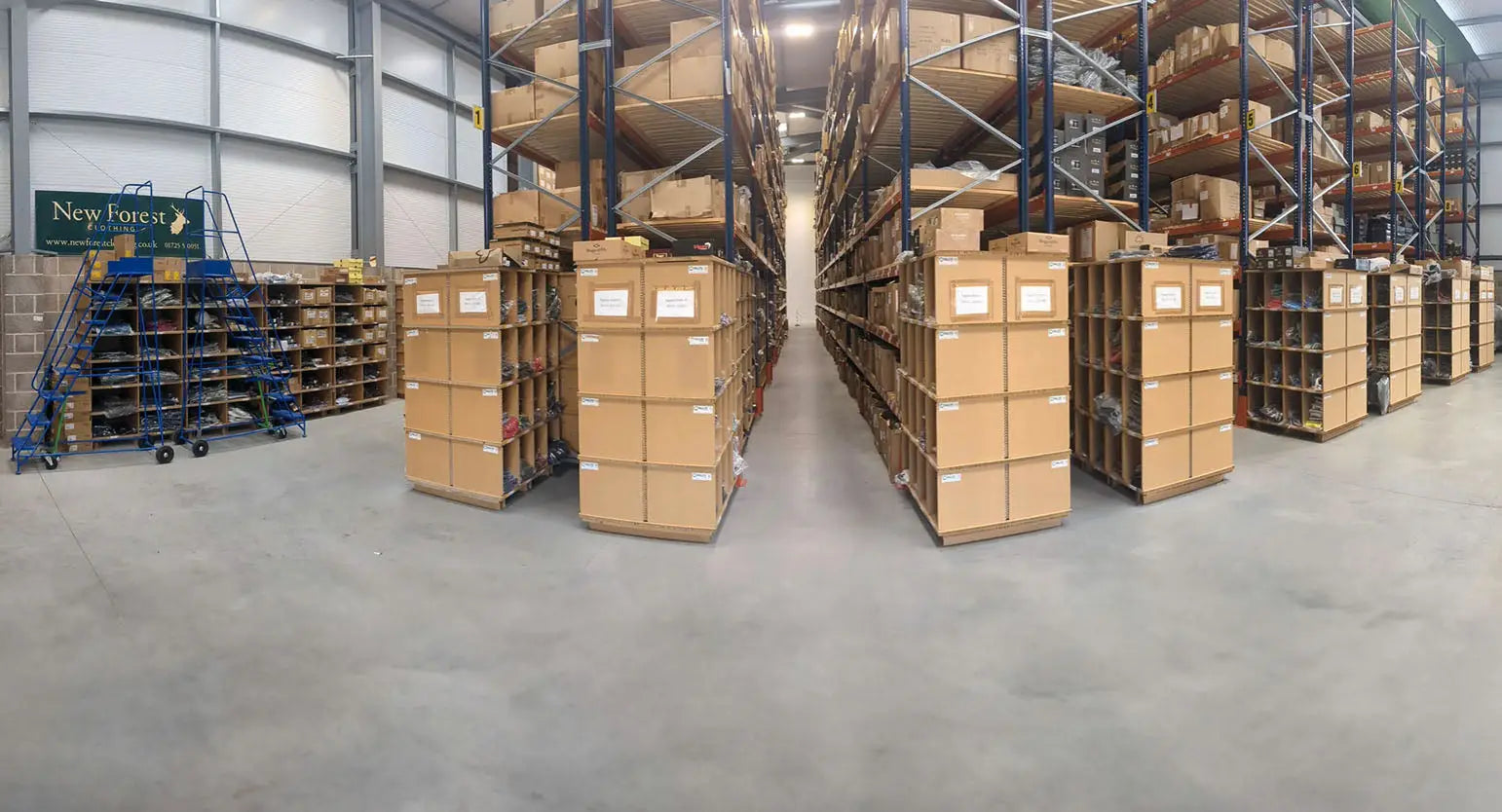 Warehouse storage area with tall shelves and stacked boxes for fast shipping times.