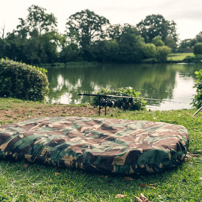 Camouflage inflatable mattress by Speero Beanie Unhooking Mat on grass by a pond