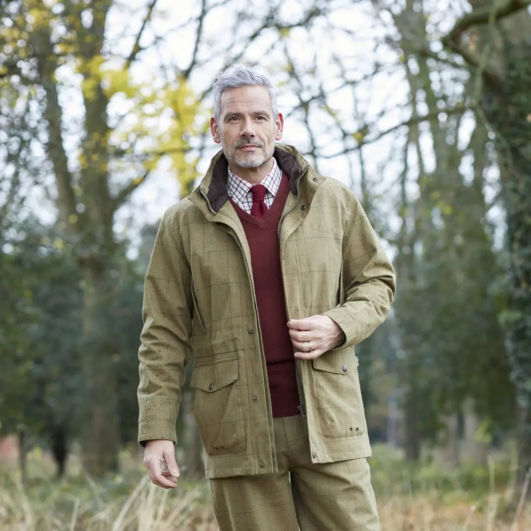 Middle-aged man in beige jacket and red sweater showcasing Alan Paine Axford coat outdoors