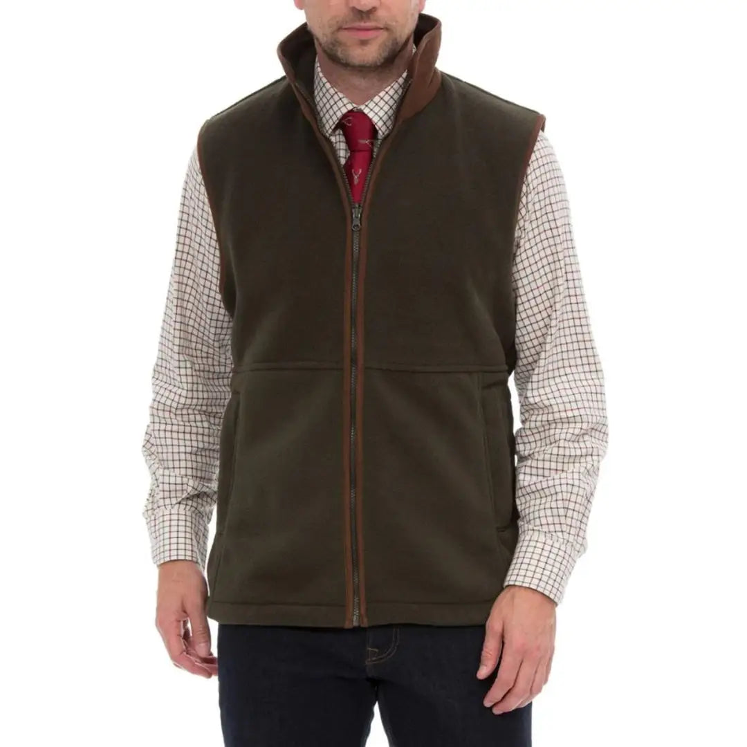 Dark green Alan Paine Aylsham fleece gilet over a checked shirt and red tie