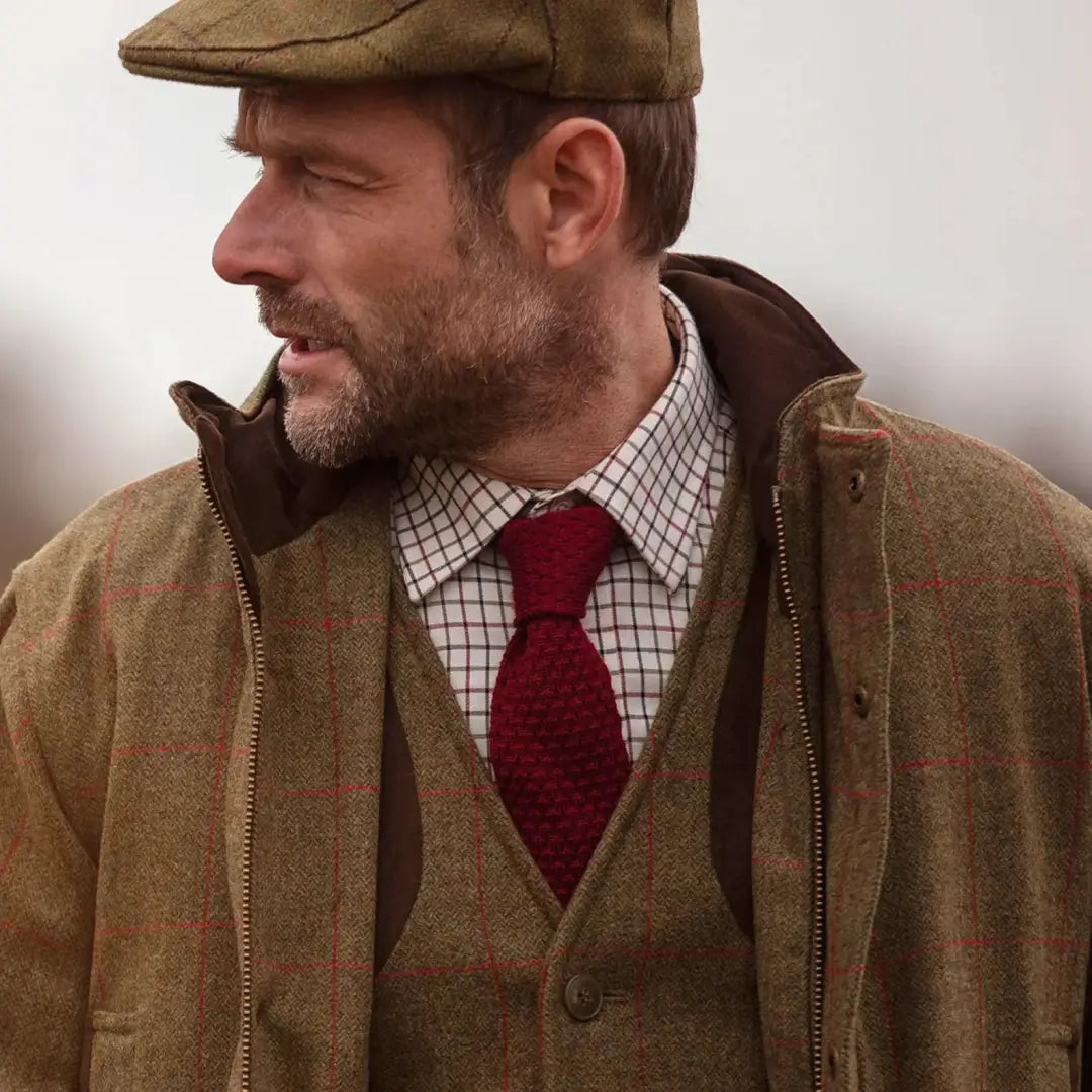 Man in traditional British country style rocking a Tweed Flat Cap and jacket