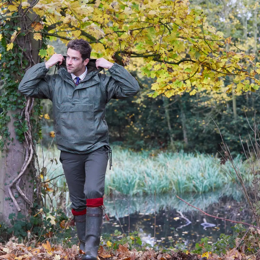 Man in Alan Paine Didsmere Smock with faux fur lining, walking in the woods