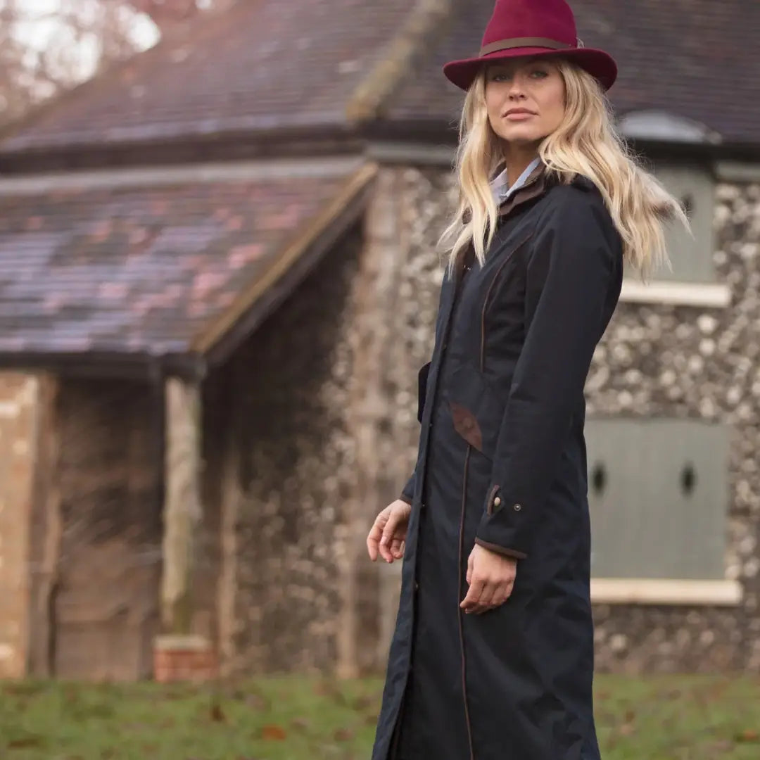 Woman in long black coat and burgundy fedora showcasing Alan Paine Fernley Ladies Waterproof