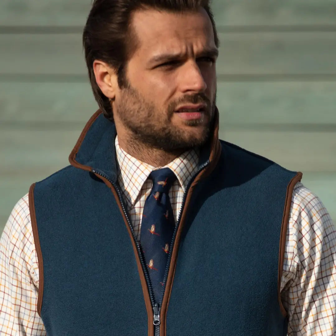 Man in a navy quilted vest with a stylish Flying Pheasant silk tie