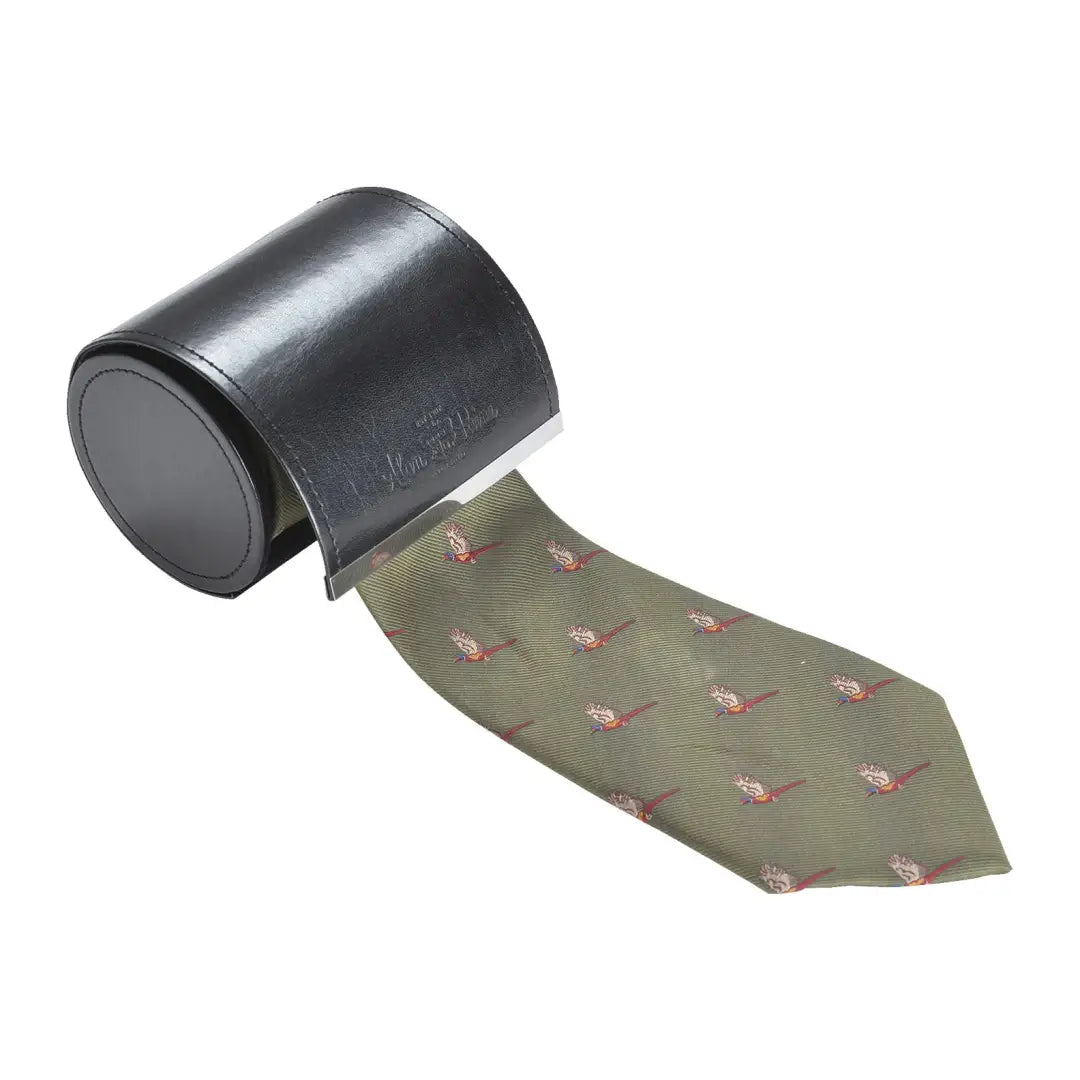 Silk tie with flying pheasant designs on green, unrolling from a sleek holder