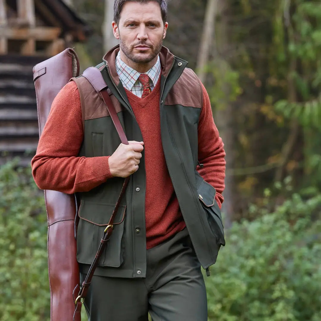 Man in a red sweater and green vest showcasing Alan Paine Stancombe Waterproof Waistcoat for hunting