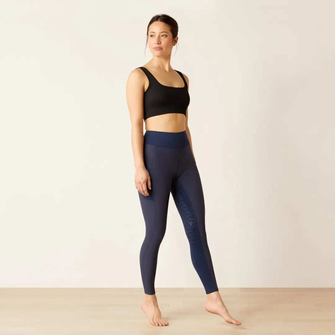 Woman in black sports bra and navy leggings, perfect for country clothing and outdoor fun