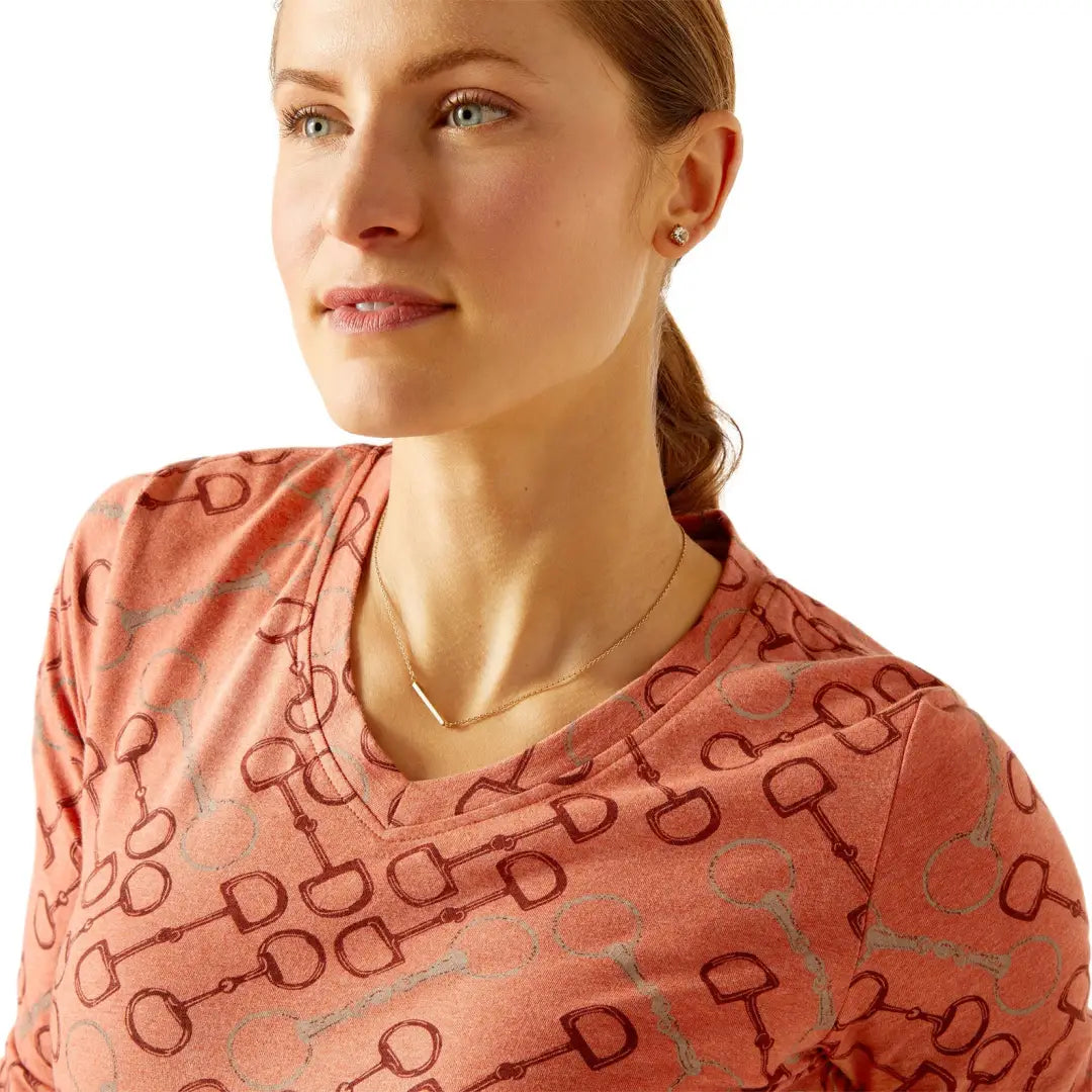 Woman in a pink patterned top, perfect for country clothing and outdoor adventures