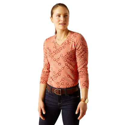 Woman in a peach long-sleeve top and dark jeans, perfect for country clothing outdoors