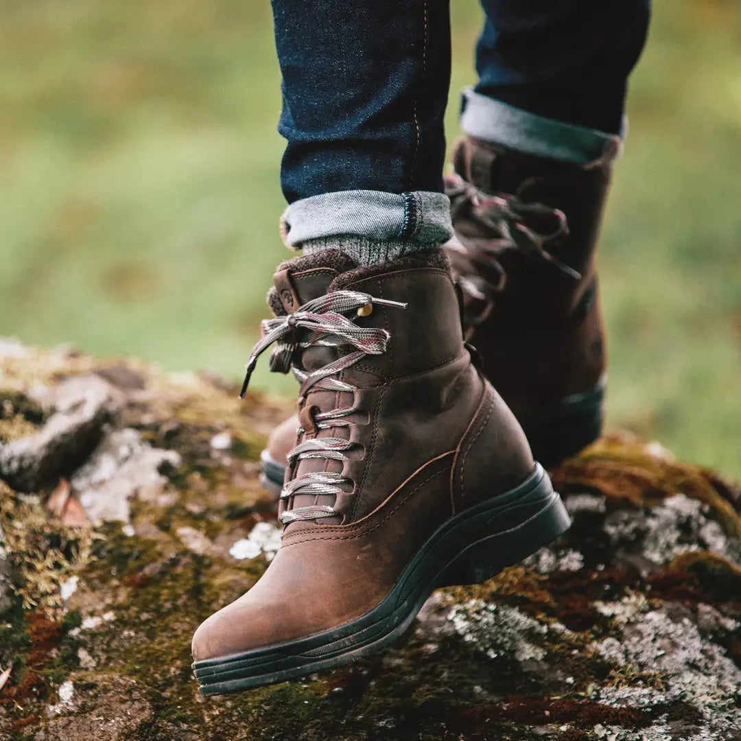 Brown leather Ariat Harper Waterproof Boots laced over jeans and cozy socks