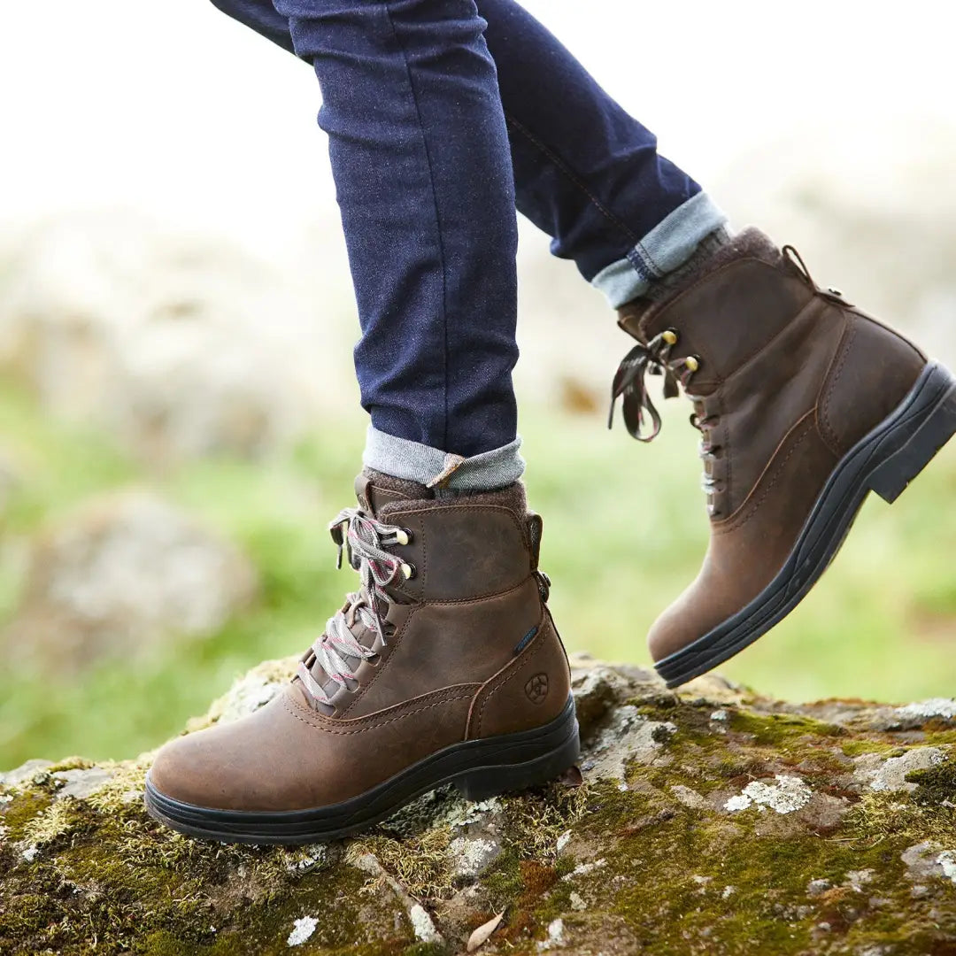 Brown leather Ariat Harper Waterproof Boots stylishly set on mossy rocks