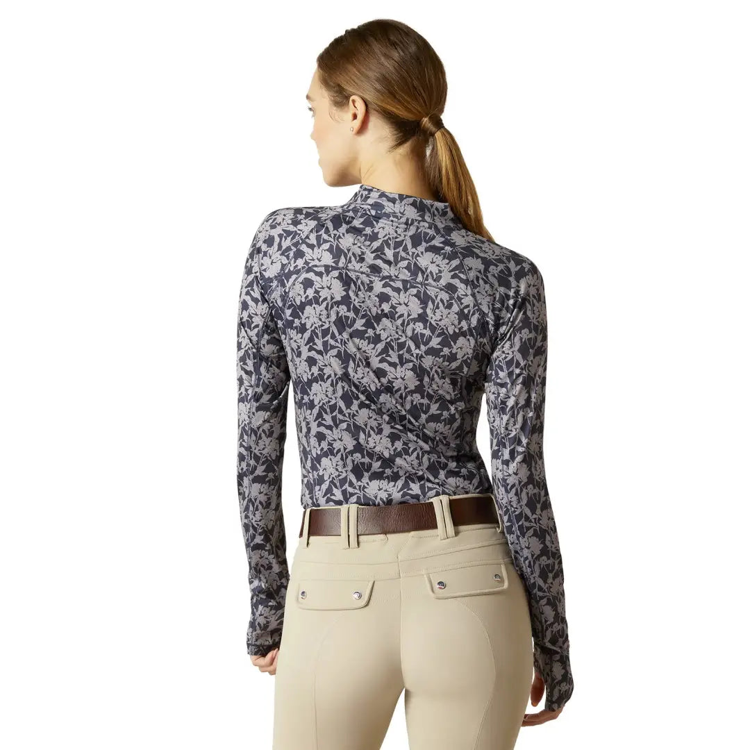 Woman in long-sleeved gray and white floral top for outdoor country clothing adventures