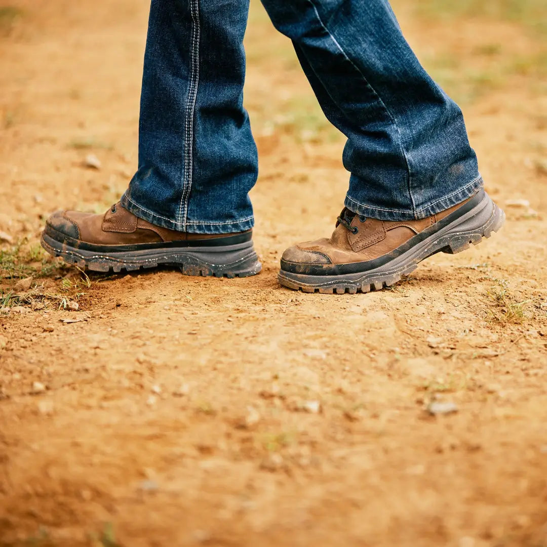 Rugged brown leather boots perfect for hunting and outdoors, paired with blue jeans