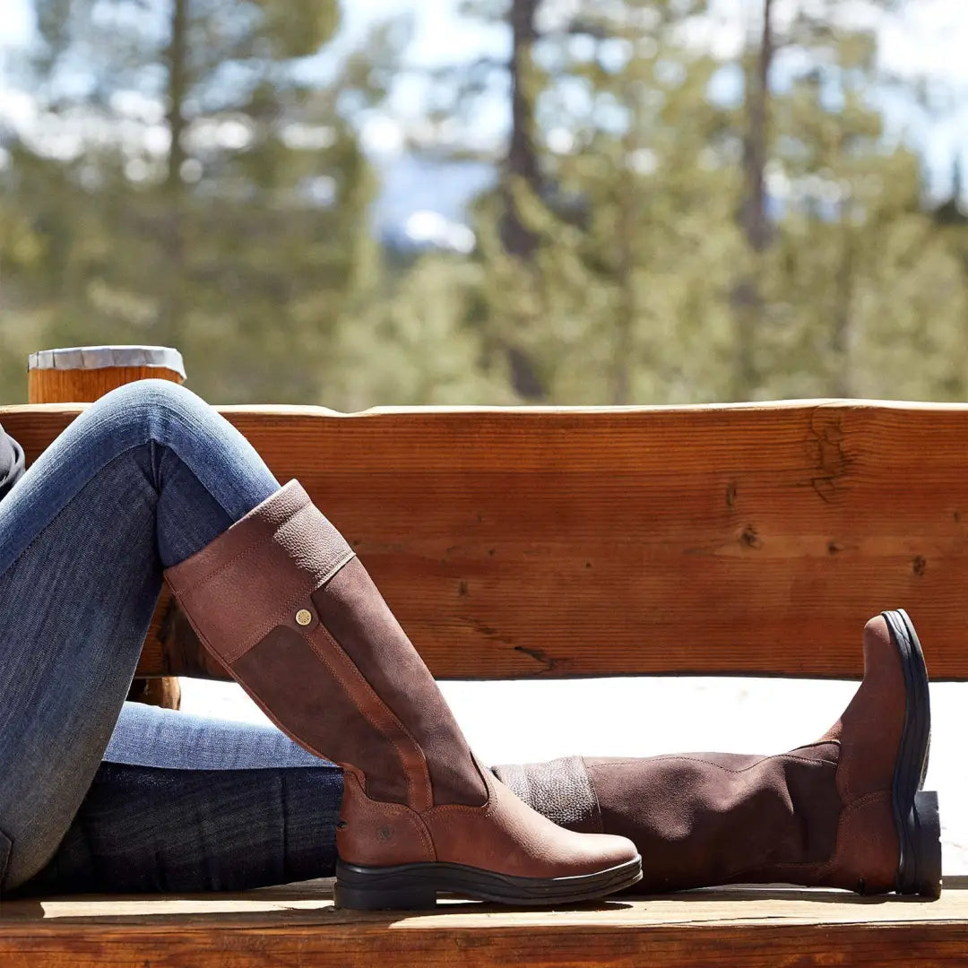 Ariat Windermere II Waterproof Boots on a bench, showcasing stylish brown leather design