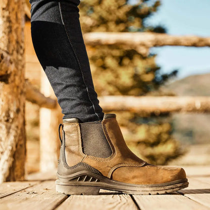 Rugged brown leather Ariat Womens Barnyard Twin Gore II boots on wood, waterproof construction delivers durability