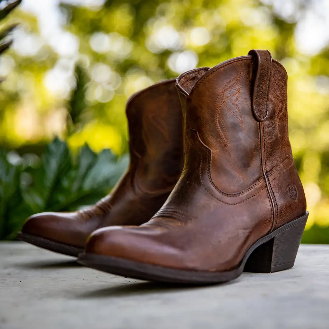 Brown leather cowboy boots perfect for country clothing and outdoor adventures