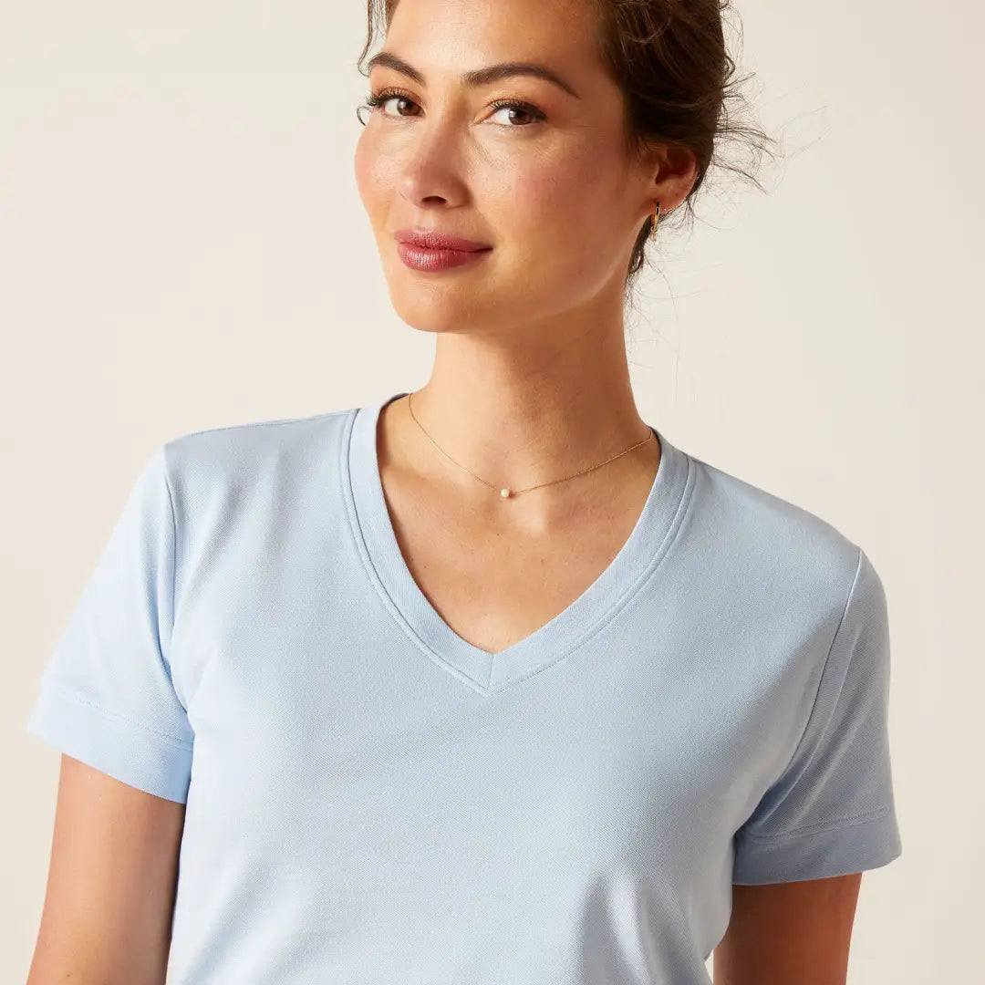 Light blue v-neck t-shirt on a woman, perfect for country clothing and outdoor adventures