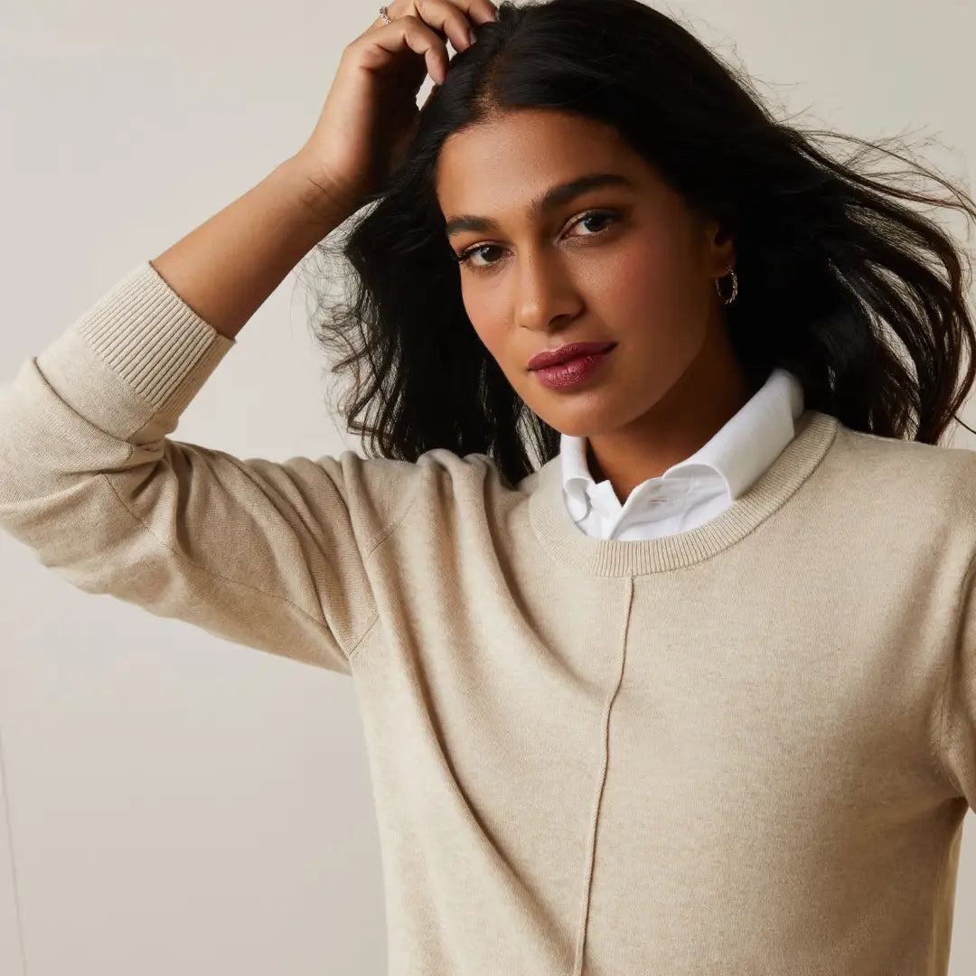 Woman in a beige sweater over a collared shirt, perfect for country clothing and outdoors