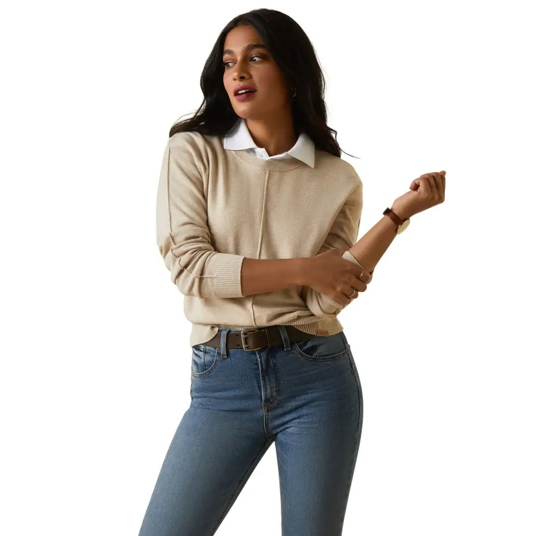 Woman in a beige sweater over a shirt and jeans, perfect for country clothing and outdoors