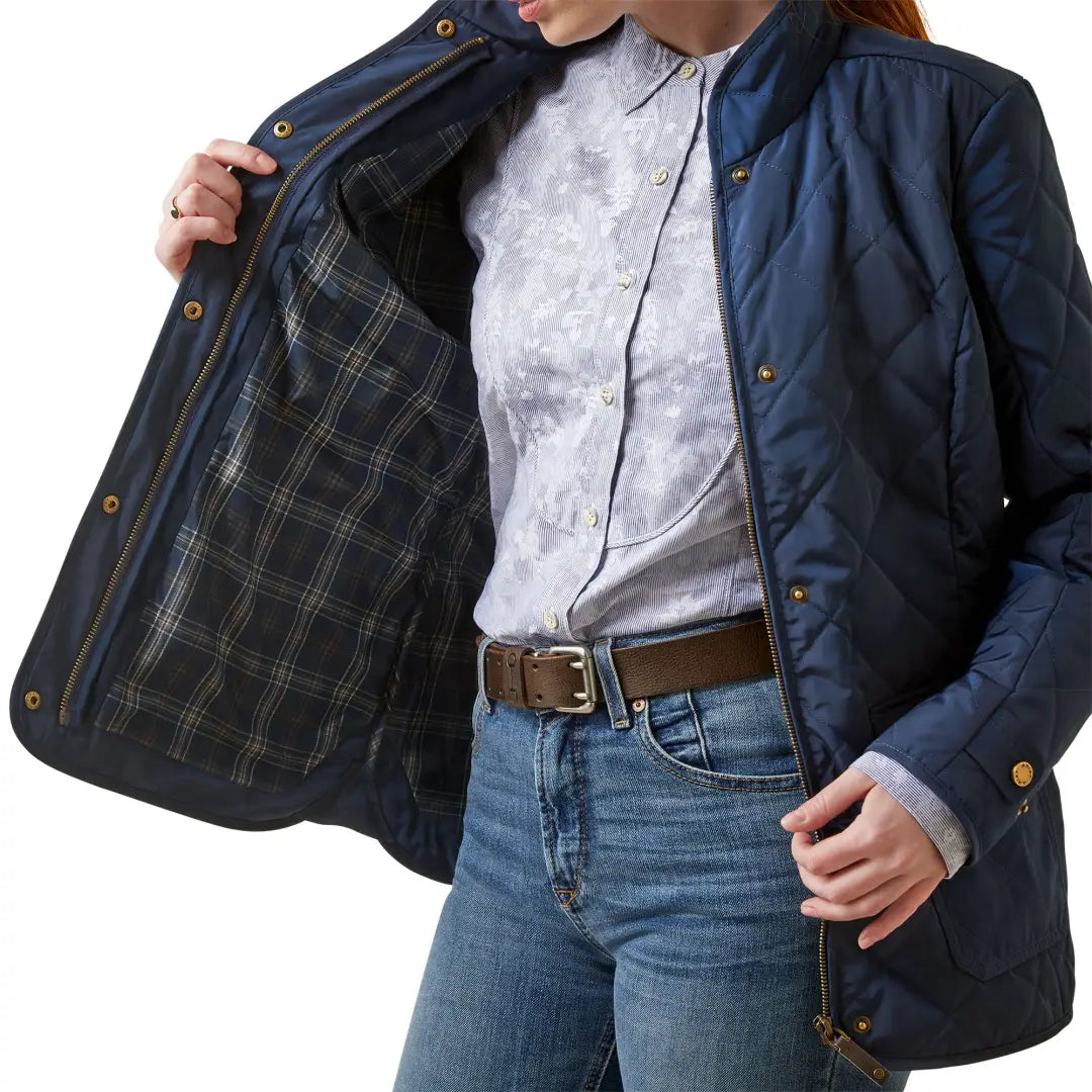 Navy blue quilted jacket with plaid lining, featuring a timeless quilted silhouette