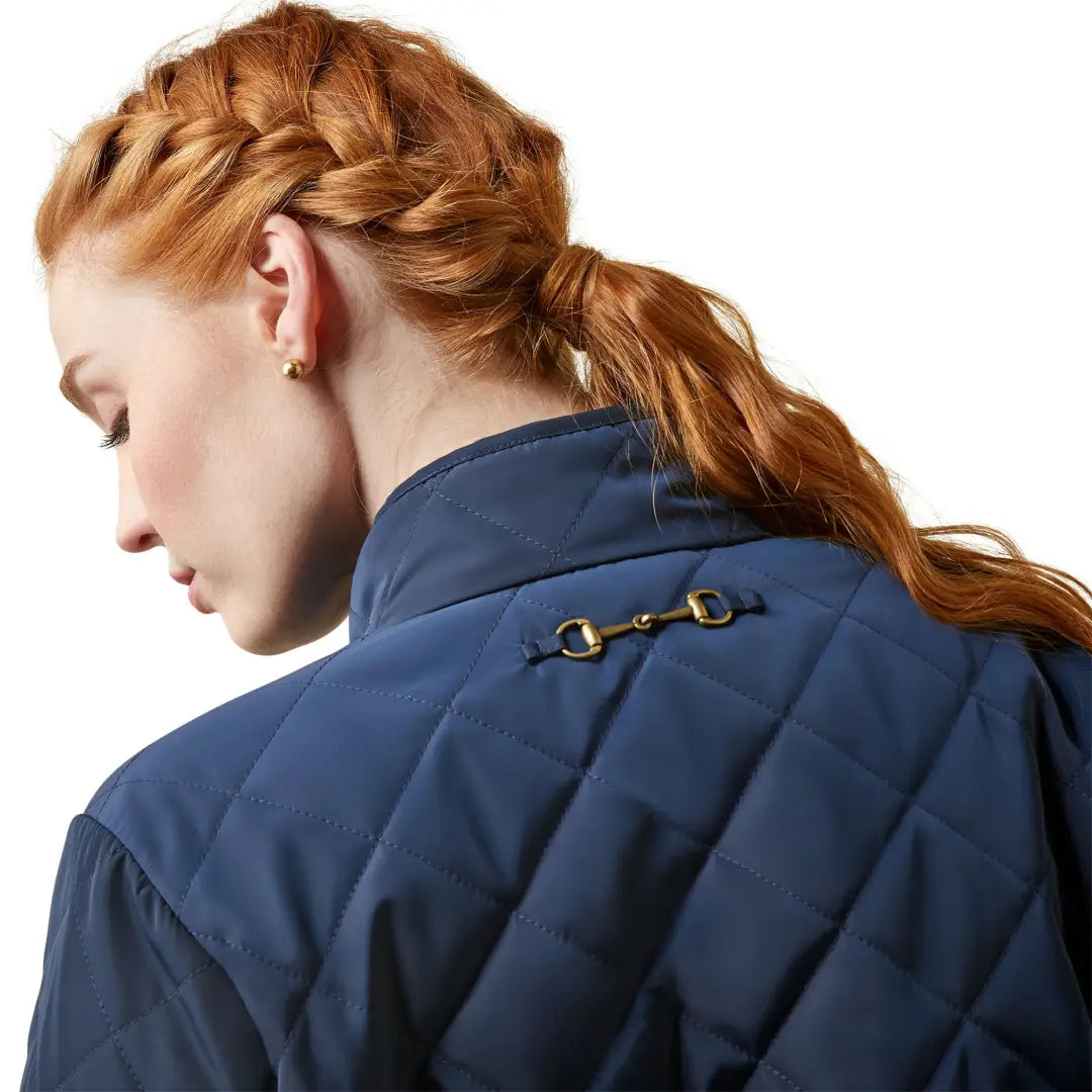 Intricate red braided hairstyle with Ariat Womens Woodside Jacket’s timeless quilted silhouette