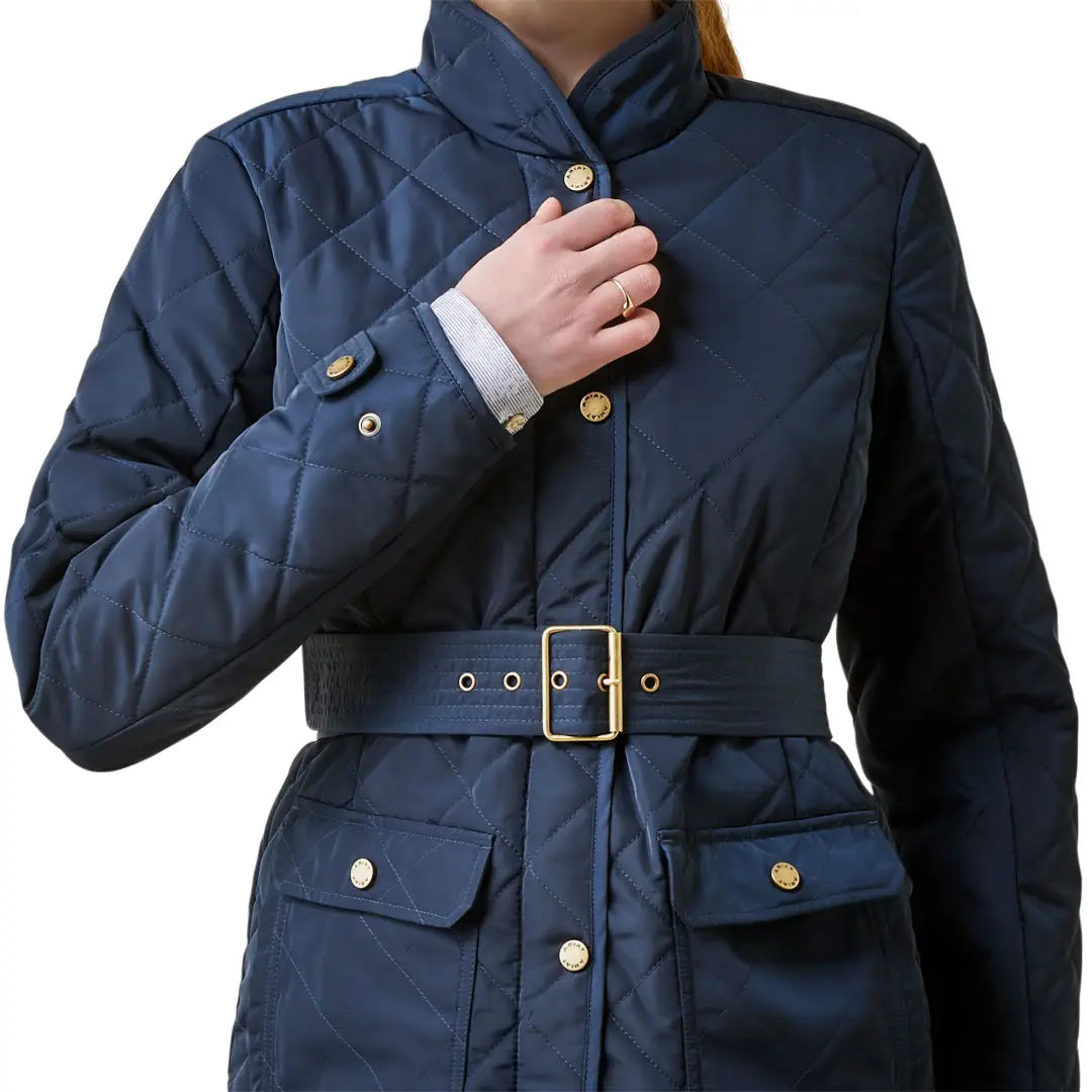 Navy blue quilted Ariat Womens Woodside Jacket with belt and gold buttons, stylish and eco-friendly