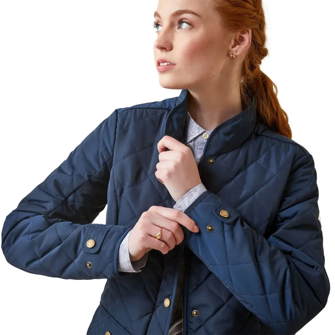 Woman in a Navy blue quilted jacket with gold buttons, featuring a timeless quilted silhouette