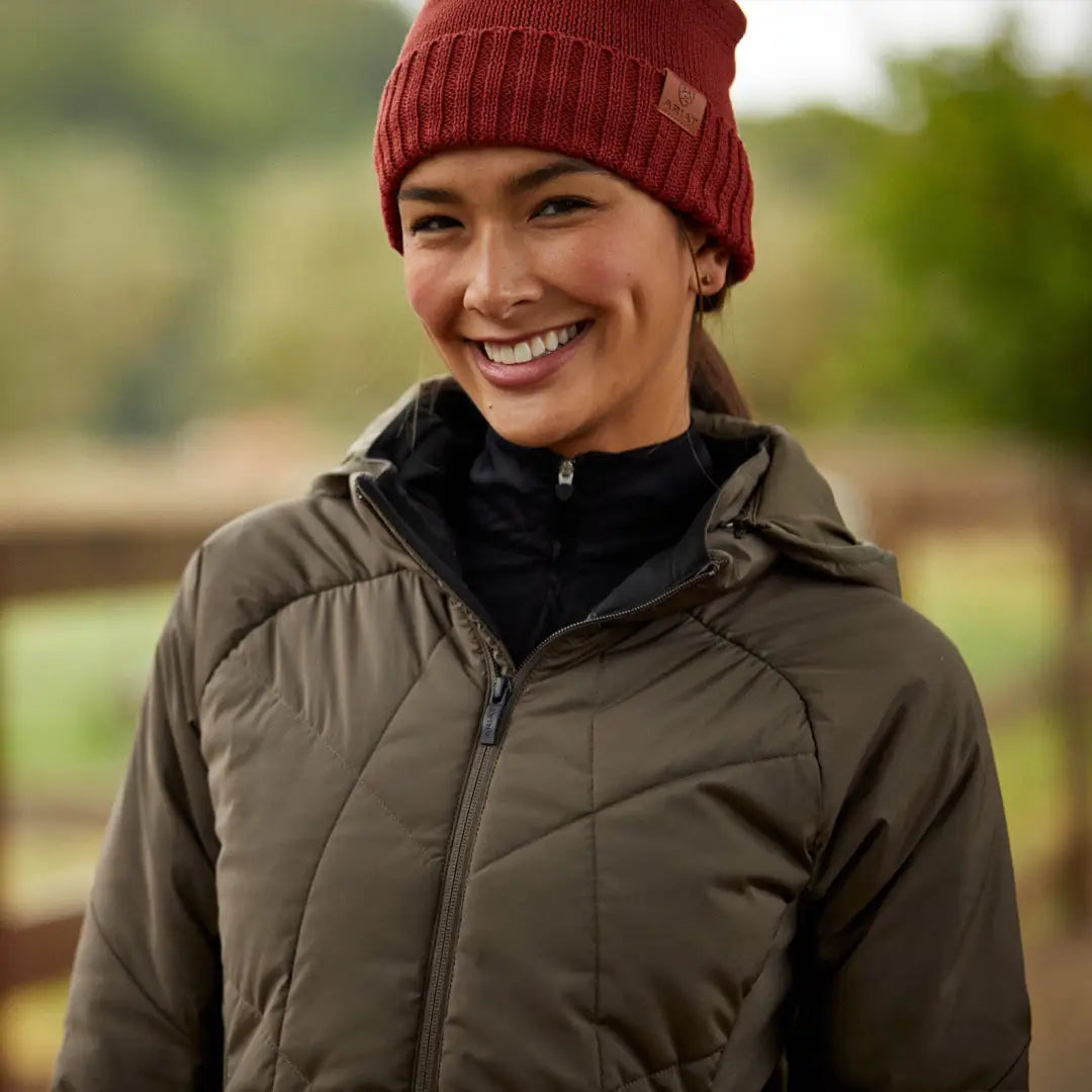 Smiling person in red knit hat and brown puffer jacket wearing a Zonal Insulated Jacket