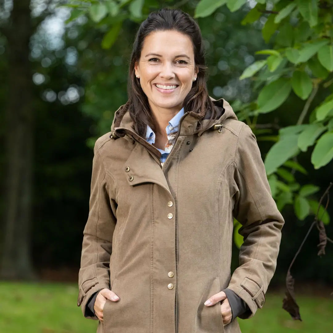 Woman in a tan Baleno Brooklands Waterproof Coat, perfect for a warm ladies town