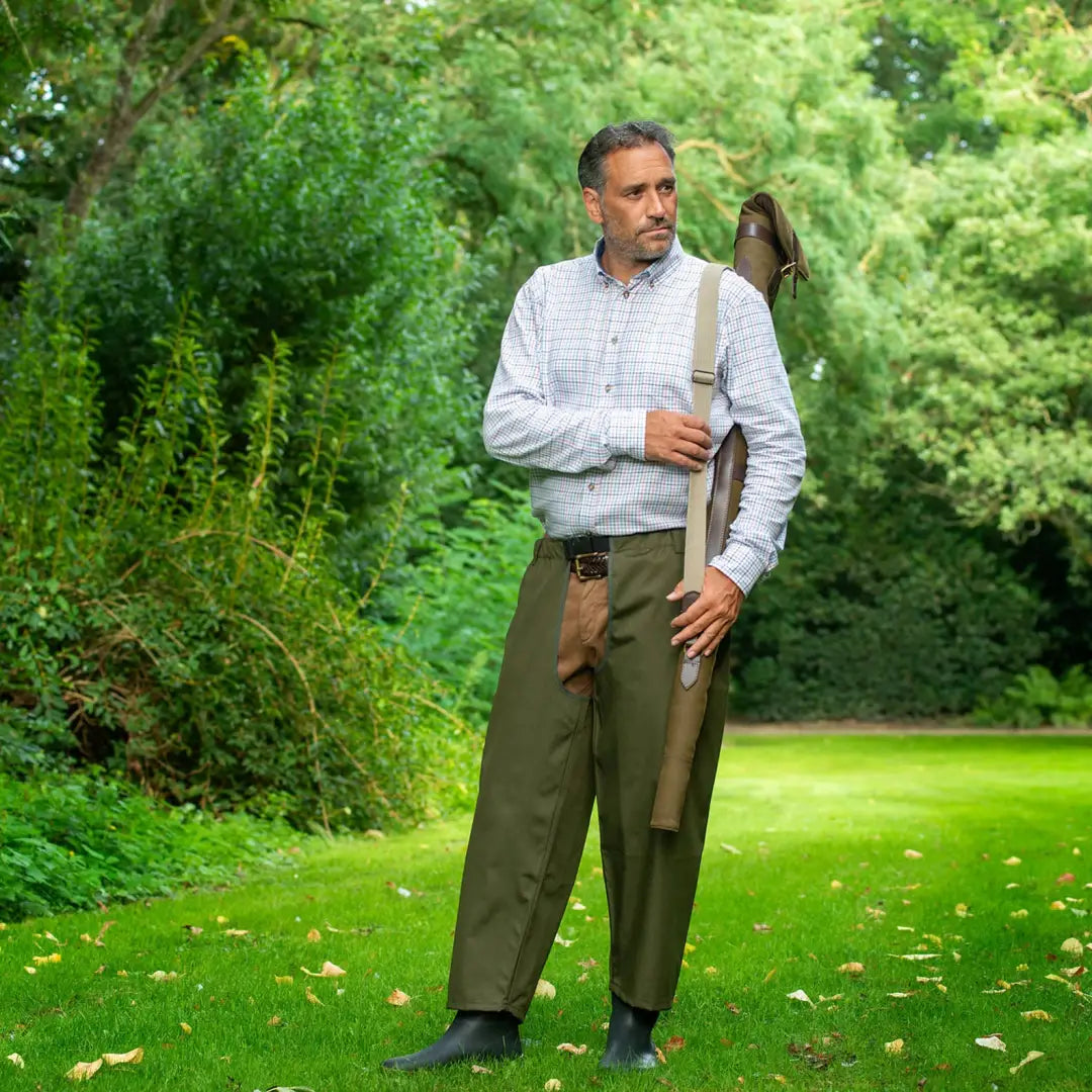 Middle-aged man in a white shirt and olive pants showcasing Baleno Buffalo Treggings in a garden