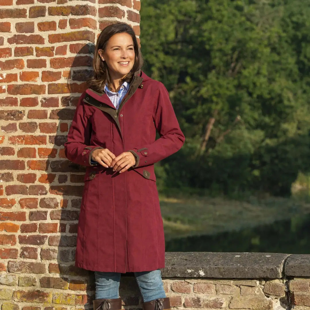 Burgundy Baleno Chelsea Waterproof Coat over jeans and boots, perfect country clothing style