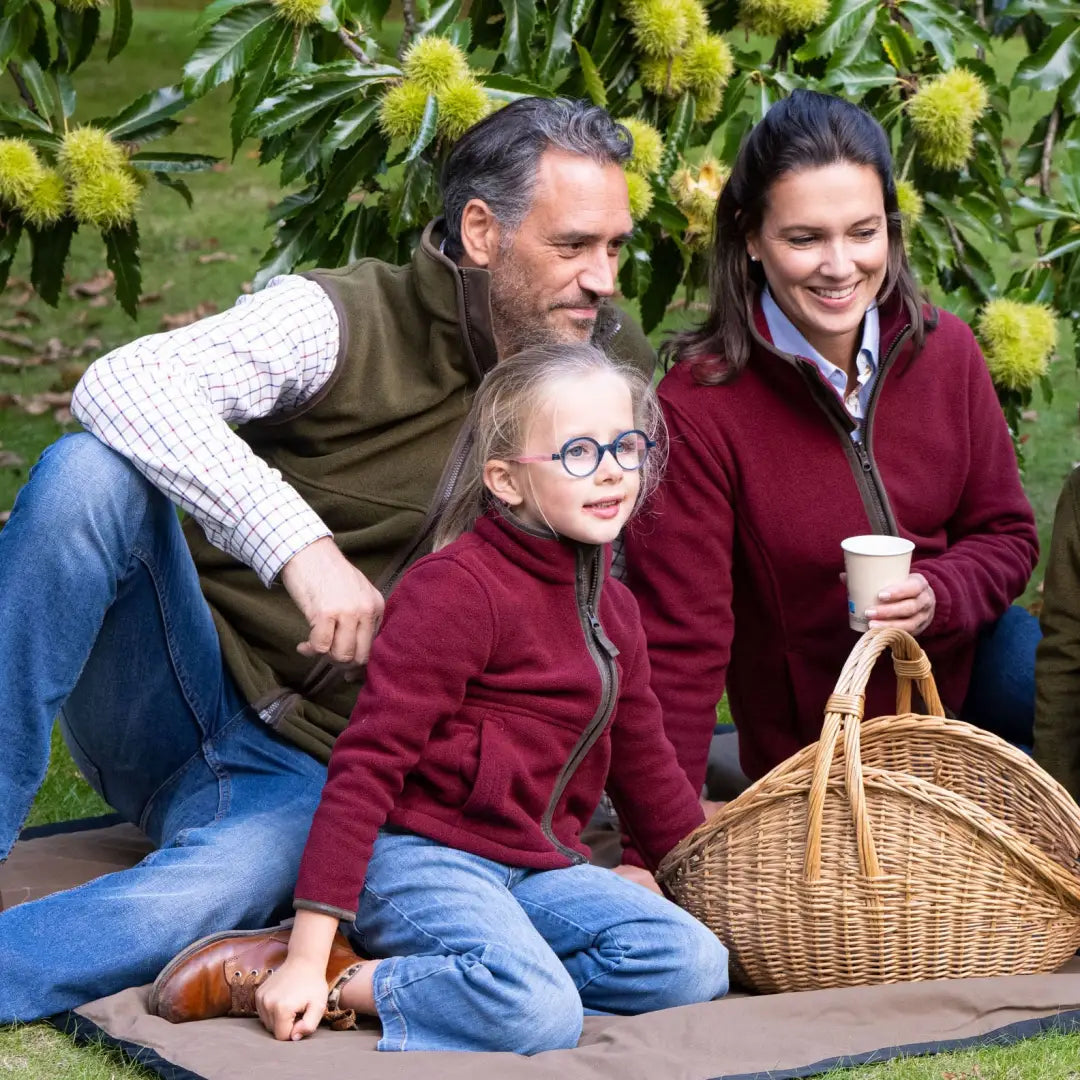 Family having fun outdoors in Baleno Cody Children’s Fleece Jacket by chestnut trees