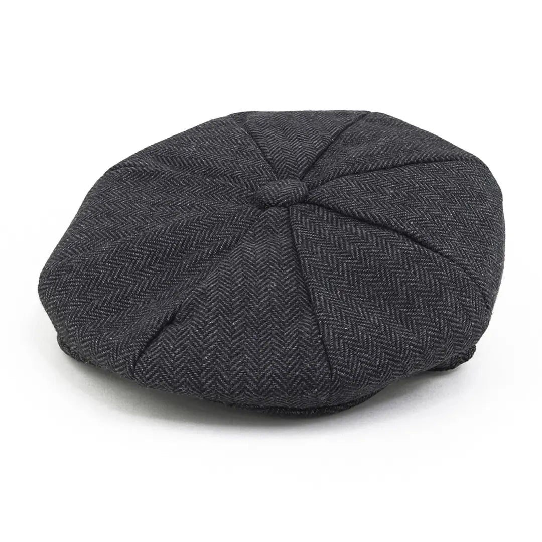 Charcoal gray herringbone tweed newsboy cap featuring interior quilting style