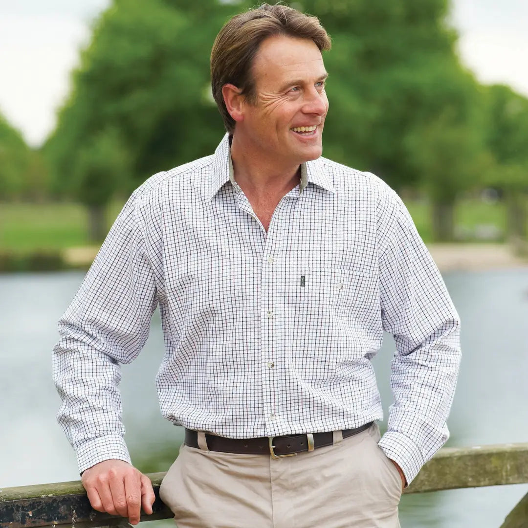 Man smiling outdoors in a Champion Ayr Super Cotton Shirt with a checkered design