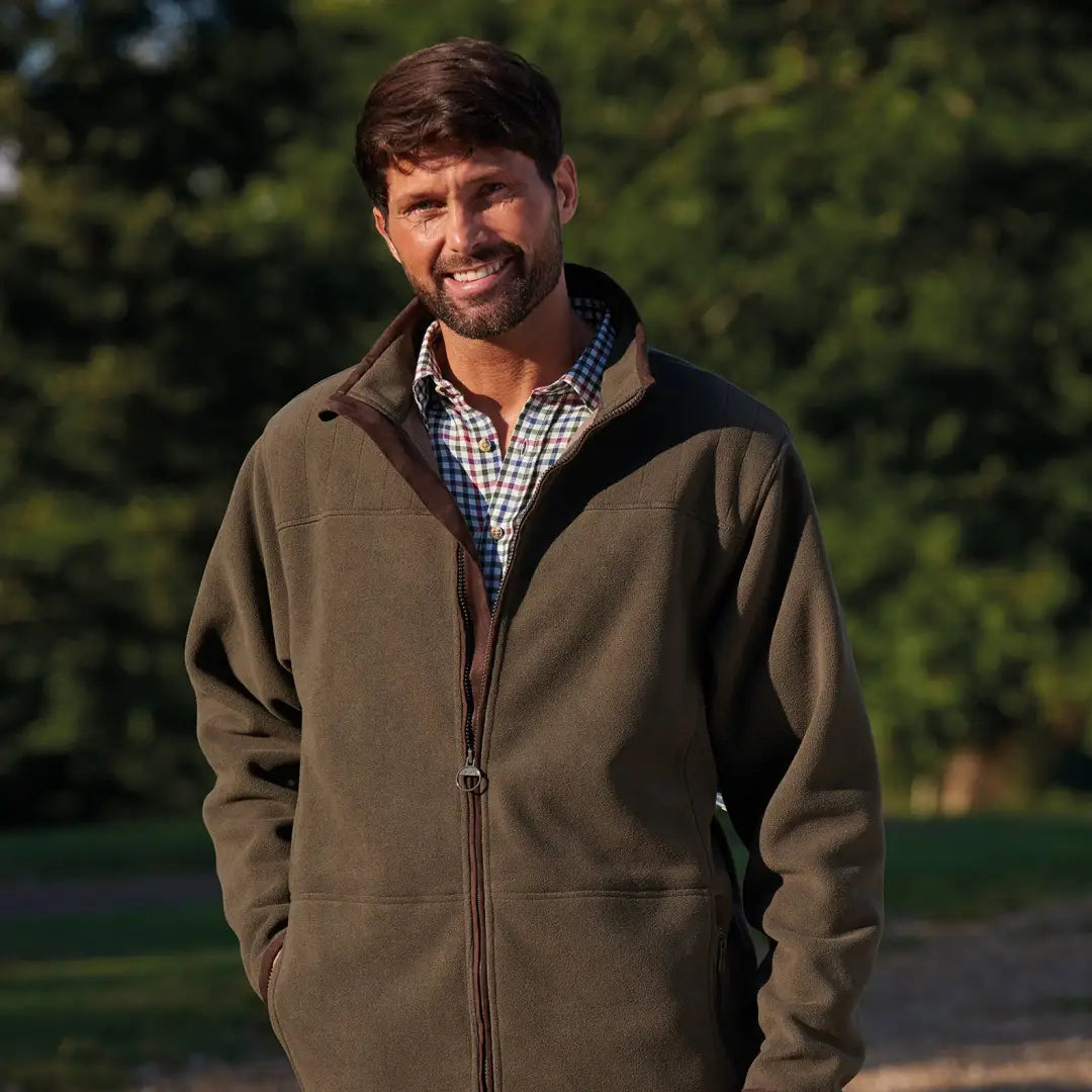 Smiling man in a brown Champion Berwick Fleece Jacket over a checkered shirt