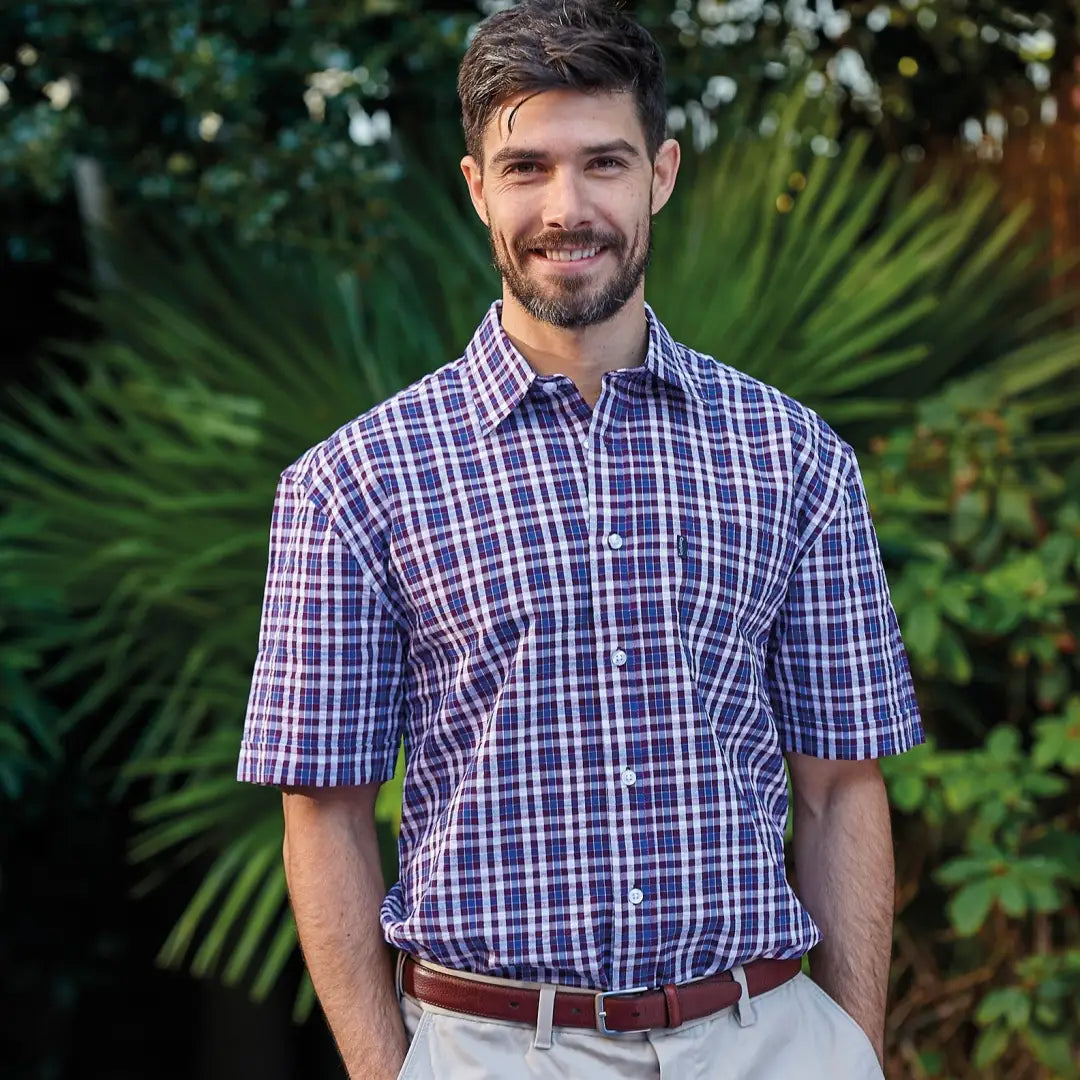 Man in a purple and white plaid Champion Croyde short sleeved shirt