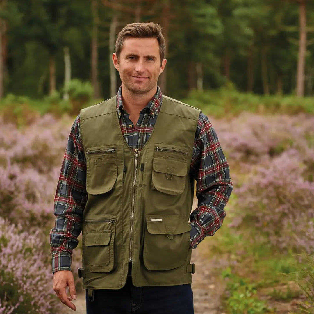 Man in a green utility vest over plaid shirt showcasing the Champion Dale Gilet