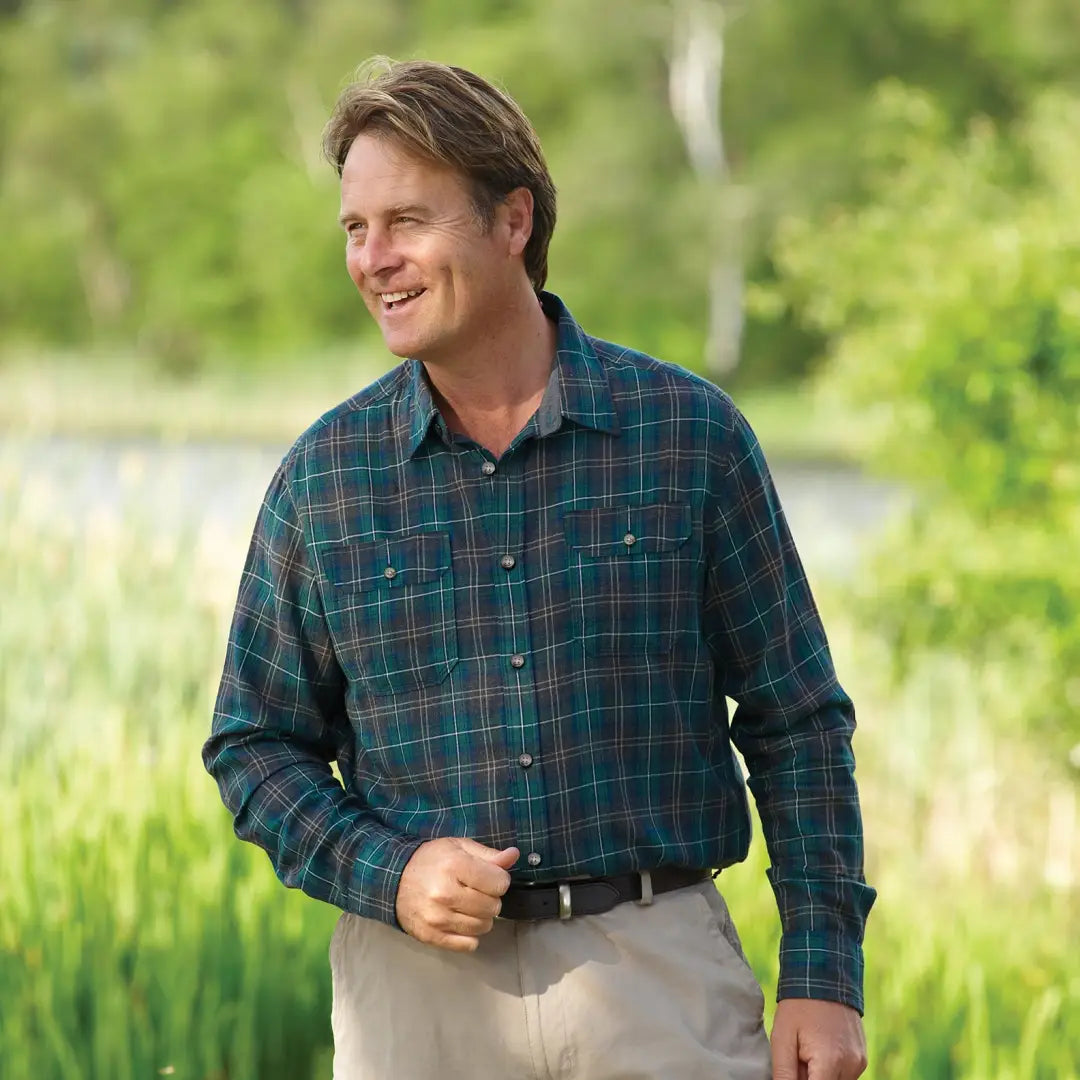 Smiling guy in a green and blue plaid Champion Kilbeggan Shirt looking stylish