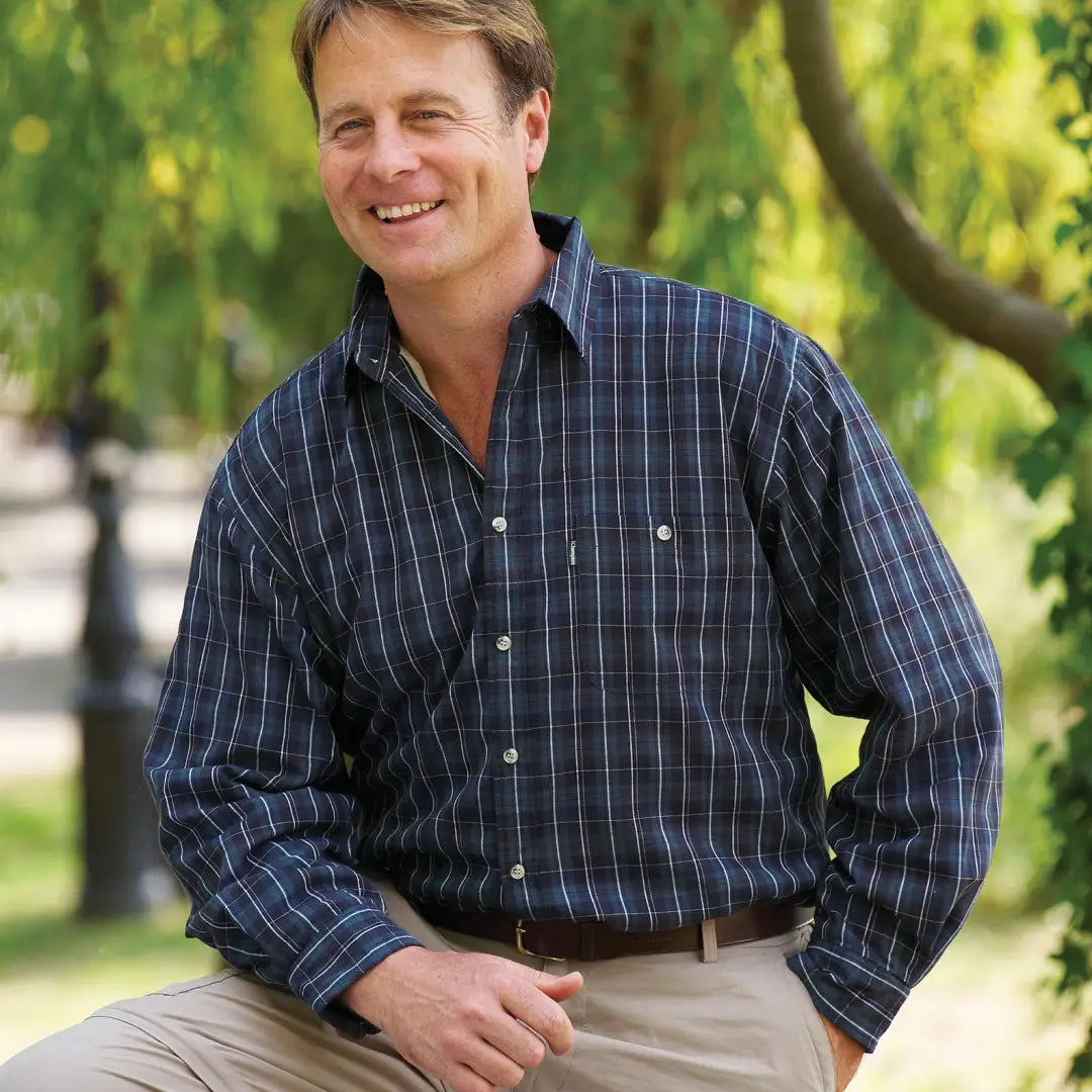 Smiling man in navy blue checkered Champion Sherborne fleece lined shirt