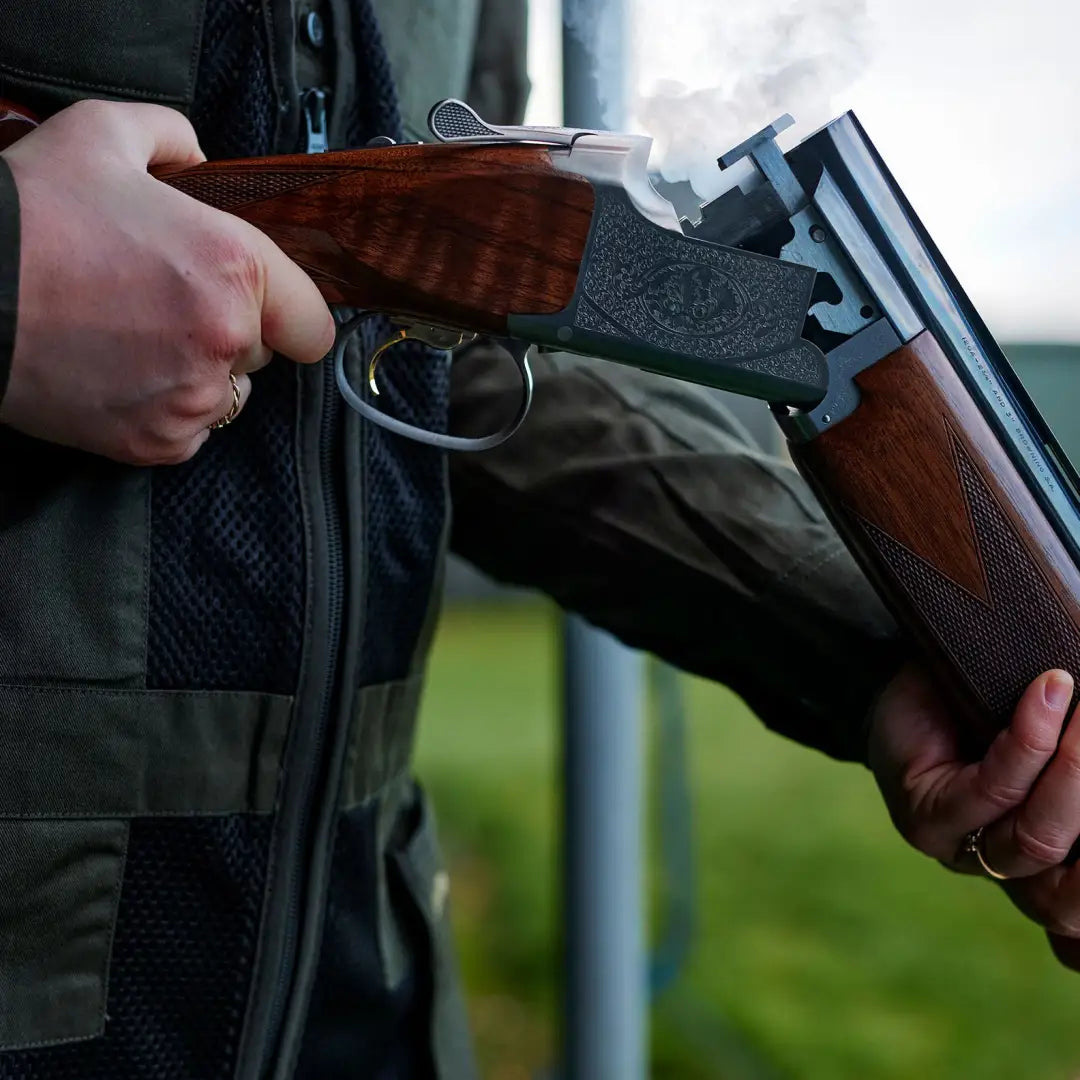 Double-barreled shotgun held open with Deerhunter Atlas Mesh Shooting Waistcoat