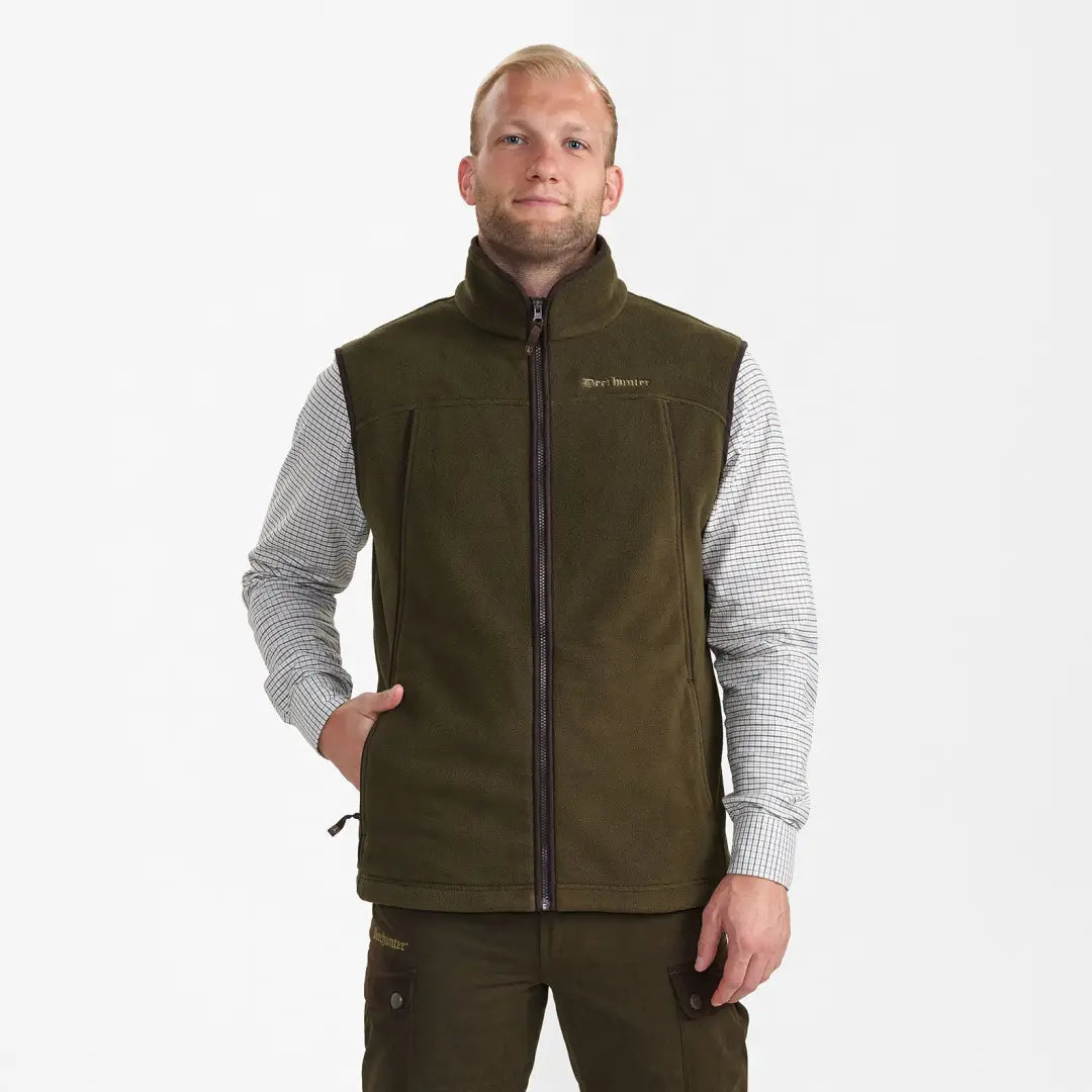 Olive green fleece waistcoat over a gray long-sleeved shirt from Deerhunter Eagle Fleece