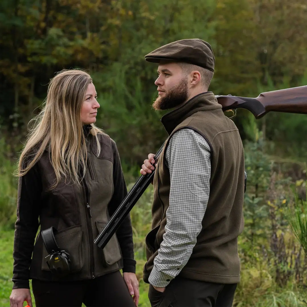 Couple in country attire showcasing the Deerhunter Eagle Fleece Waistcoat outdoors