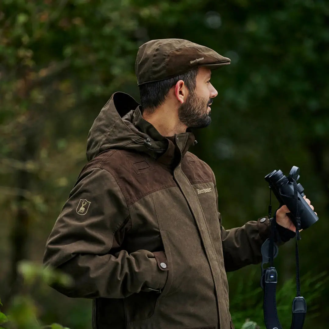 Bearded man in brown Eagle Jacket with binoculars, ready for active hunts in any weather