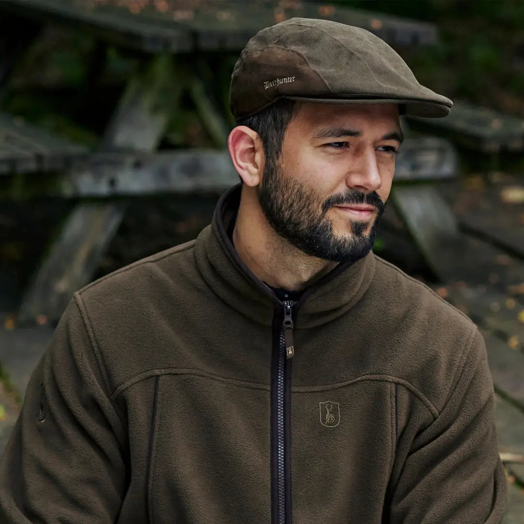 Man in flat cap and fleece jacket, perfect for country clothing and hunting