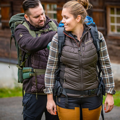 Hiking couple adjusting backpacks while wearing the Lady Caroline Padded Waistcoat