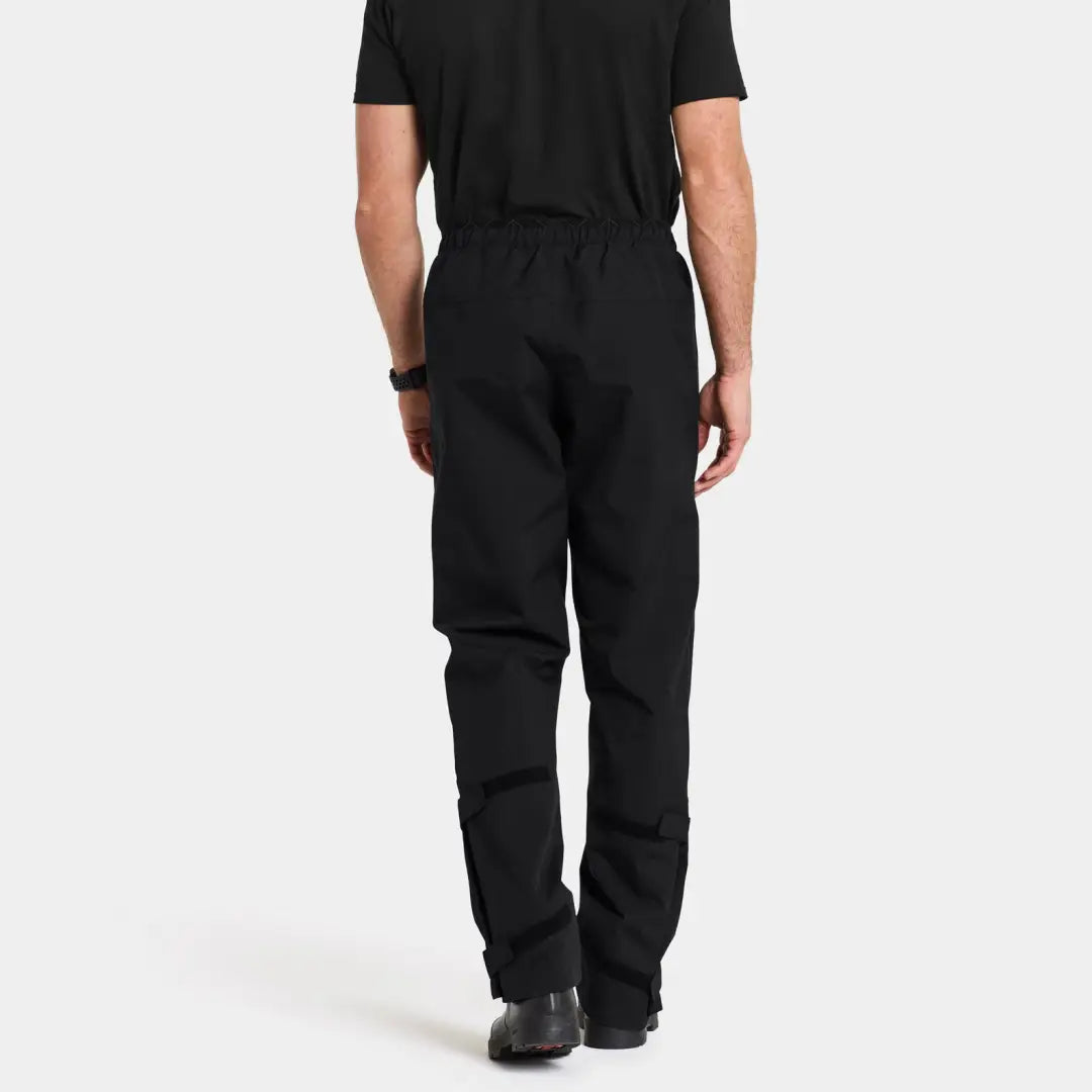 Black rain pants worn by a person from behind showcasing Didriksons Grit Rain Pants 2