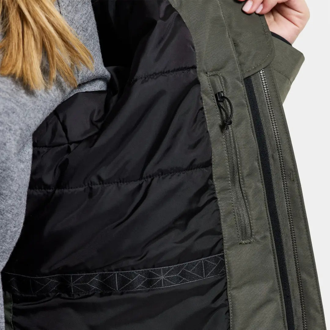 Winter jacket featuring olive green exterior and black quilted lining, classic parka style